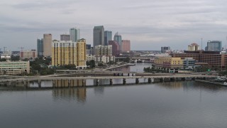 DX0003_229_046 - 5.7K aerial stock footage of the skyline seen while ascending over bridges, Downtown Tampa, Florida