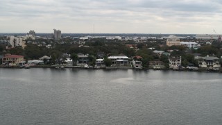 DX0003_230_017 - 5.7K aerial stock footage of passing by waterfront mansions in Tampa, Florida