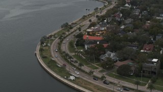 DX0003_230_020 - 5.7K aerial stock footage reverse view of waterfront homes and Bayshore Blvd in Tampa, Florida