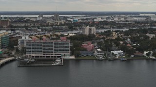 DX0003_230_021 - 5.7K aerial stock footage of passing by waterfront mansions and condo complex in Tampa, Florida