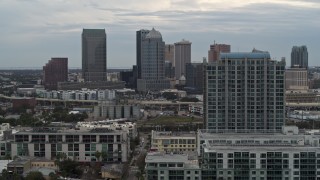 DX0003_230_027 - 5.7K aerial stock footage of flying by apartment complex, reveal skyline, Downtown Tampa, Florida