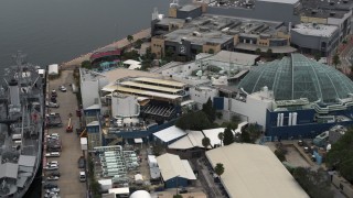 DX0003_230_030 - 5.7K aerial stock footage reverse view of a warship museum and aquarium in Tampa, Florida