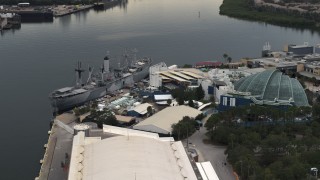DX0003_230_033 - 5.7K aerial stock footage of circling a warship museum and aquarium in Tampa, Florida
