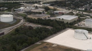DX0003_230_034 - 5.7K aerial stock footage of warehouse buildings and storage tanks in Tampa, Florida