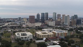 DX0003_231_008 - 5.7K aerial stock footage orbit apartment buildings, reveal skyscrapers in the city's skyline, Downtown Tampa, Florida