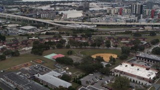 DX0003_231_013 - 5.7K aerial stock footage of apartment buildings by elementary school, Tampa, Florida