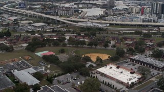 DX0003_231_014 - 5.7K aerial stock footage orbit and fly away from apartment buildings by elementary school, Tampa, Florida