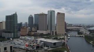 DX0003_231_017 - 5.7K aerial stock footage reverse view of skyscrapers by the river during descent, Downtown Tampa, Florida