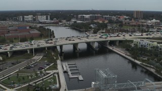 DX0003_231_029 - 5.7K aerial stock footage orbit and approach traffic on a bridge spanning the river in Tampa, Florida