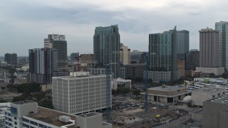 DX0003_231_033 - 5.7K aerial stock footage orbit the Times Building to focus on high-rises in Downtown Tampa, Florida