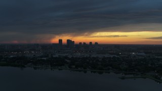 DX0003_231_042 - 5.7K aerial stock footage of the distant city skyline of Downtown Tampa, Florida at sunset