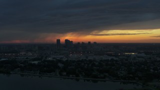 DX0003_231_049 - 5.7K stock footage aerial video a reverse view of the Downtown Tampa skyline from the bay at sunset, Florida