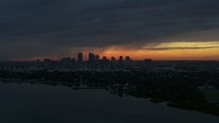 DX0003_231_051 - 5.7K stock footage aerial video a view of the Downtown Tampa skyline while flying over the bay at sunset, Florida
