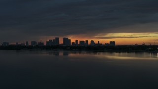 DX0003_231_053 - 5.7K aerial stock footage fly toward Downtown Tampa skyline from the bay at sunset, Florida