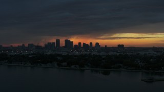 DX0003_231_054 - 5.7K stock footage aerial video ascending toward Downtown Tampa skyline from the bay at sunset, Florida