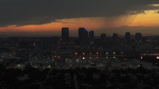 DX0003_232_017 - 5.7K aerial stock footage slowly fly away from skyscrapers in the Downtown Tampa skyline at twilight, Florida