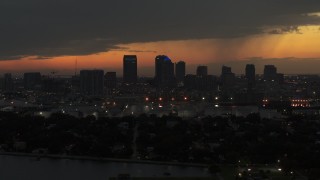 DX0003_232_018 - 5.7K aerial stock footage descend past skyscrapers in the Downtown Tampa skyline at twilight, Florida