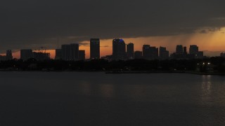 DX0003_232_020 - 5.7K stock footage aerial video fly low over bay with view of skyscrapers in the Downtown Tampa skyline at twilight, Florida