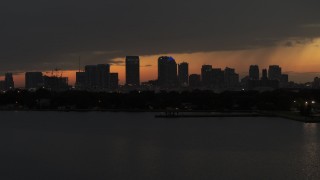 DX0003_232_021 - 5.7K stock footage aerial video fly over bay with view of skyscrapers in the Downtown Tampa skyline at twilight, Florida