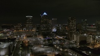 DX0003_232_027 - 5.7K aerial stock footage orbit and fly away from skyscrapers at night in Downtown Tampa, Florida