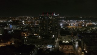 DX0003_232_038 - 5.7K aerial stock footage of orbiting apartment building at nighttime in Downtown Tampa, Florida