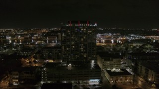 DX0003_232_039 - 5.7K aerial stock footage of circling an apartment building at night in Downtown Tampa, Florida