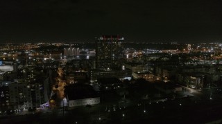 DX0003_232_040 - 5.7K aerial stock footage of an orbit of an apartment building at night in Downtown Tampa, Florida