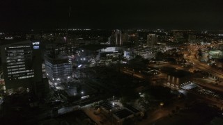 DX0003_232_043 - 5.7K aerial stock footage ascend away from Amalie Arena at night in Downtown Tampa, Florida