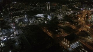 DX0003_232_045 - 5.7K aerial stock footage of slowly flying away from Amalie Arena at night in Downtown Tampa, Florida