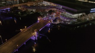 DX0003_232_047 - 5.7K aerial stock footage of police cars on the bridge by convention center at night in Downtown Tampa, Florida