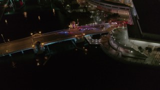 DX0003_232_051 - 5.7K aerial stock footage circle and fly away from police cars on the bridge by convention center at night in Downtown Tampa, Florida