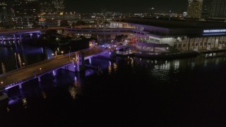 DX0003_232_053 - 5.7K aerial stock footage police cars on a bridge by convention center at night in Downtown Tampa, Florida