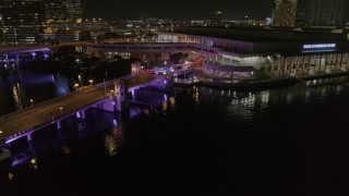 DX0003_232_054 - 5.7K aerial stock footage orbit police cars on a bridge by convention center at night in Downtown Tampa, Florida