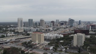 DX0003_233_002 - 5.7K aerial stock footage of a reverse view of the city's skyline, Downtown Orlando, Florida