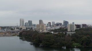 DX0003_233_006 - 5.7K aerial stock footage descend away from hotel and the city's skyline, Downtown Orlando, Florida