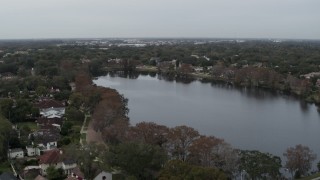 DX0003_233_012 - 5.7K aerial stock footage of approaching waterfront homes around Lake Adair, Orlando, Florida