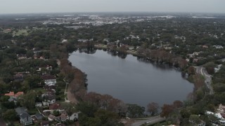 DX0003_233_013 - 5.7K aerial stock footage ascend away from waterfront homes around Lake Adair, Orlando, Florida