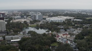 DX0003_233_017 - 5.7K aerial stock footage of orbiting Lake Dot and apartment buildings in Orlando, Florida