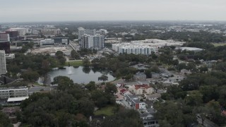 DX0003_233_018 - 5.7K aerial stock footage of flying past Lake Dot and apartment buildings in Orlando, Florida
