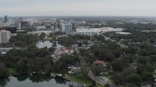 DX0003_233_019 - 5.7K aerial stock footage of flying away from Lake Dot and apartment buildings in Orlando, Florida