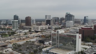 DX0003_233_031 - 5.7K aerial stock footage fly away from city's skyline, reveal hotel, Downtown Orlando, Florida