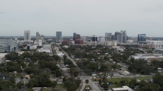 DX0003_233_046 - 5.7K aerial stock footage of slowly flying by the city's skyline, Downtown Orlando, Florida