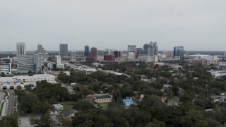 DX0003_233_048 - 5.7K aerial stock footage focus on the city's skyline during descent, Downtown Orlando, Florida
