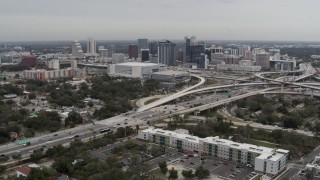 DX0003_234_002 - 5.7K aerial stock footage stationary view of Amway Center, city skyline, and freeway interchange, Downtown Orlando, Florida