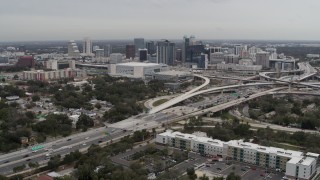 DX0003_234_003 - 5.7K aerial stock footage of Amway Center, city skyline beside freeway interchange, Downtown Orlando, Florida