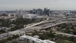 DX0003_234_005 - 5.7K aerial stock footage descend past Amway Center, city skyline beside freeway interchange, Downtown Orlando, Florida