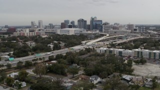 DX0003_234_007 - 5.7K aerial stock footage a view of Amway Center, city skyline, freeway interchange, Downtown Orlando, Florida