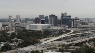 DX0003_234_016 - 5.7K aerial stock footage of flying by Amway Center and city skyline, Downtown Orlando, Florida