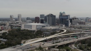 DX0003_234_017 - 5.7K aerial stock footage of passing by Amway Center and city skyline, Downtown Orlando, Florida
