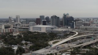 DX0003_234_018 - 5.7K aerial stock footage of ascending by Amway Center and city skyline, Downtown Orlando, Florida